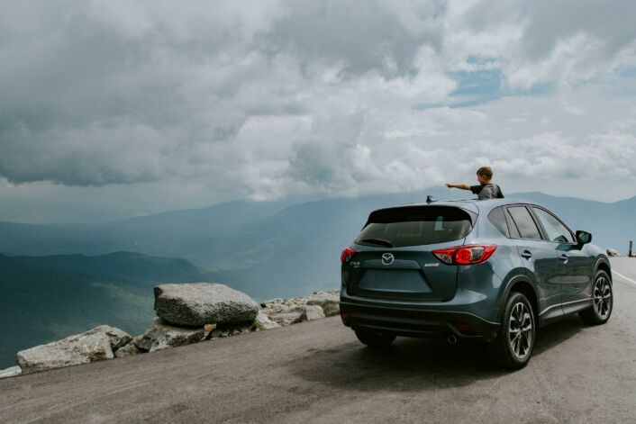 An SUV overlooking a valley. Find out the best SUVs in New Zealand.