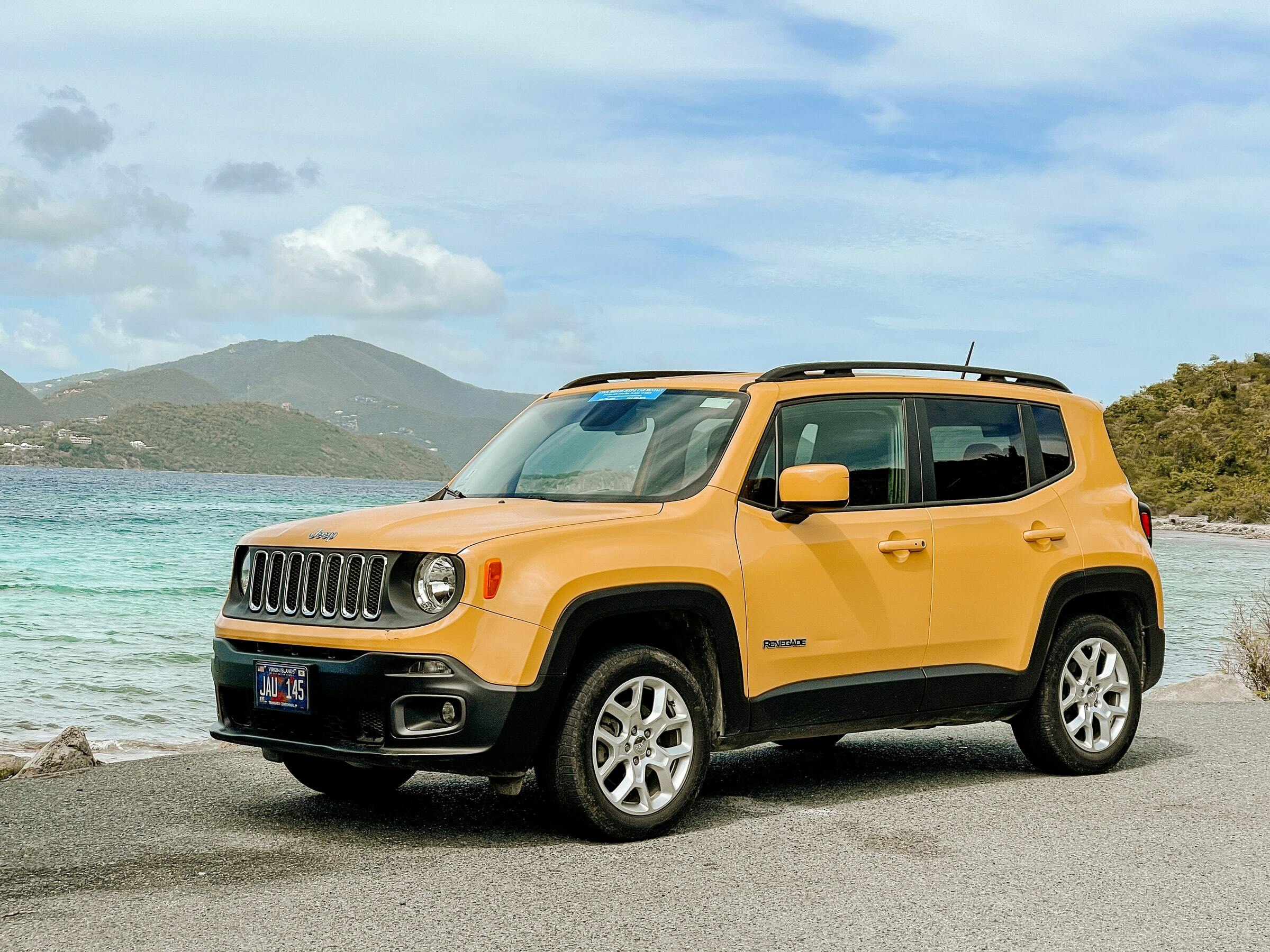 A car stopped by the water on one of the best road trips in New Zealand